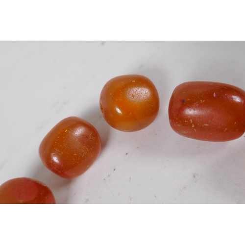 629 - A quantity of loose butterscotch amber beads, 51g