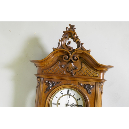 633 - A fine C19th Vienna wall clock in walnut case with carved and applied moulded detail, the brass and ... 