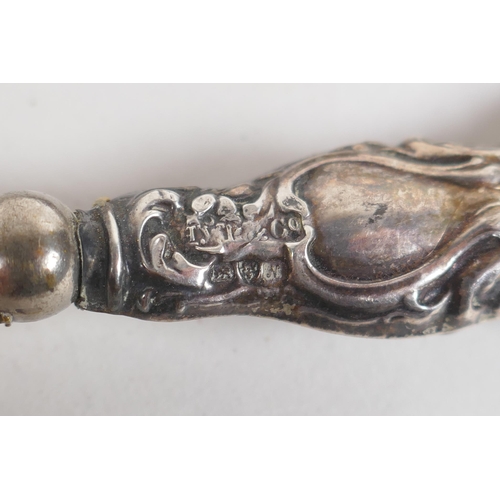 638 - An antique French silver handled lamb leg holder, together with and antique hallmarked silver handle... 