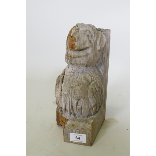 64 - An antique carved and weathered pine gargoyle term/mount, 26cm high