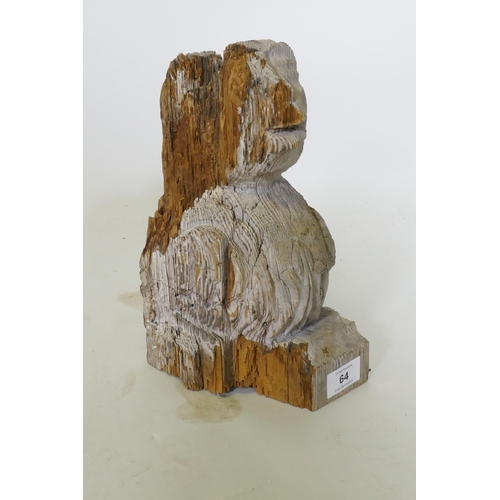 64 - An antique carved and weathered pine gargoyle term/mount, 26cm high