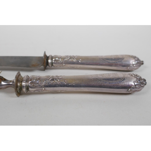 655 - A C19th French silver handled carving knife and fork set, with deer decoration, boxed, 33cm long