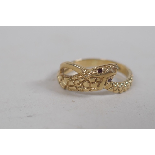 676 - A 9ct gold snake ring set with ruby eyes, 3g