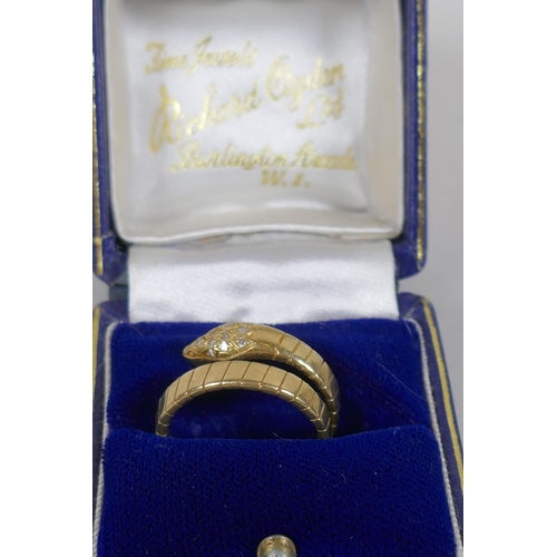 677 - An 18ct gold snake ring, the head and eyes set with diamonds, 7.3g approx size N