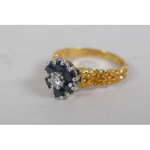 678 - An 18ct gold cluster ring, set with six sapphires and a central diamond, size K, 4g