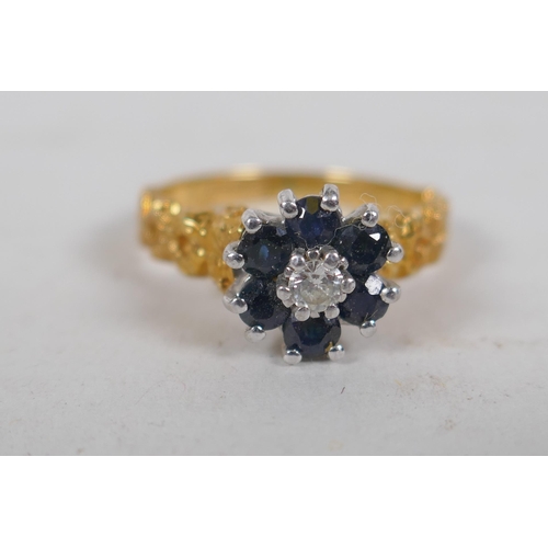 678 - An 18ct gold cluster ring, set with six sapphires and a central diamond, size K, 4g