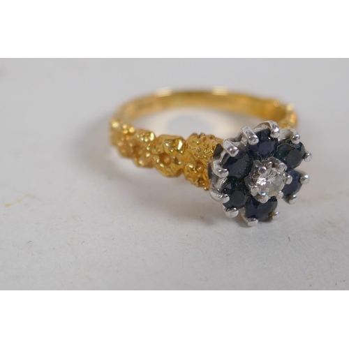 678 - An 18ct gold cluster ring, set with six sapphires and a central diamond, size K, 4g