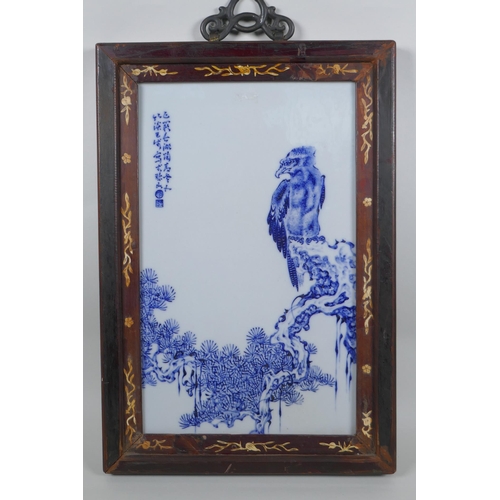 68 - A Chinese blue and white panel depicting an eagle in an inlaid hardwood frame, 30 x 44cm