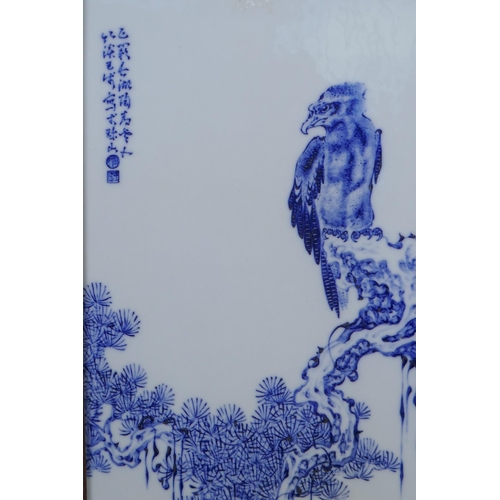 68 - A Chinese blue and white panel depicting an eagle in an inlaid hardwood frame, 30 x 44cm