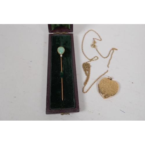 682 - A 9ct gold heart shaped locket and chain, 7.3g, and a 14ct gold hat pin set with jade and a pearl