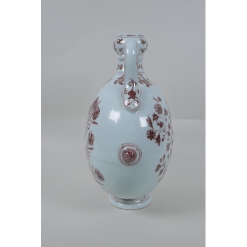 73 - A red and white porcelain two handled moon flask with floral decoration, Chinese Xuande 6 character ... 