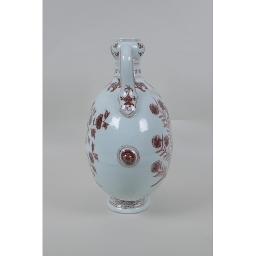 73 - A red and white porcelain two handled moon flask with floral decoration, Chinese Xuande 6 character ... 