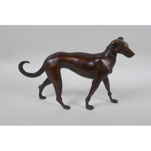 74 - A filled bronze figure of a dog, 32cm long