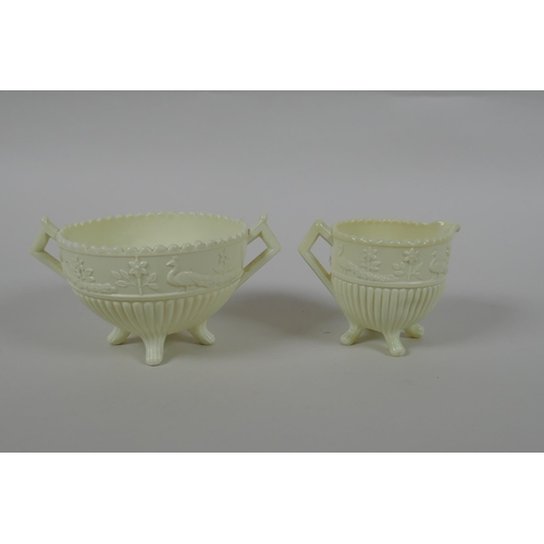 76 - Two Victorian Sowerby patent ivory Queens Ware glass pots with peacock decoration, 8cm diameter