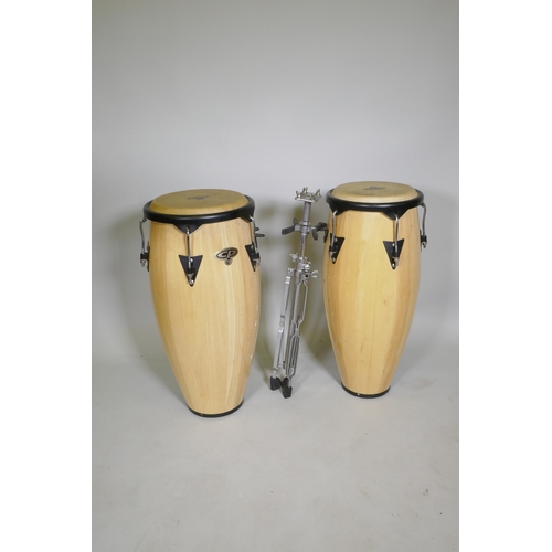 81 - A pair of Latin percussion CP Congas and stand, 30cm diameter and 33cm diameter