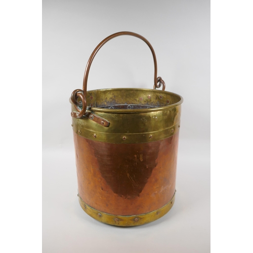 84 - An antique brass and copper riveted coal bucket, 33cm high x 31cm diameter