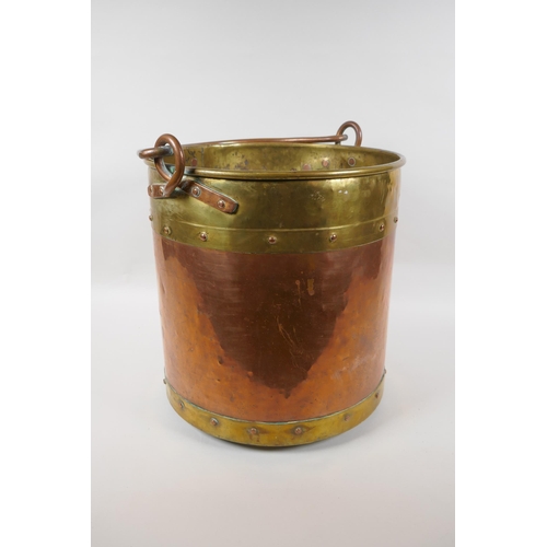 84 - An antique brass and copper riveted coal bucket, 33cm high x 31cm diameter