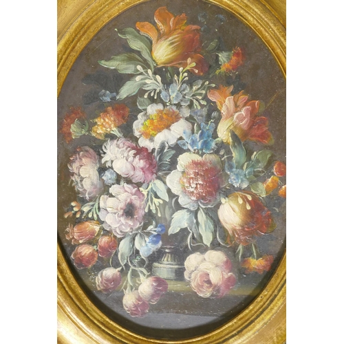 864 - A pair of still life, flowers, in the C18th style, unsigned, in oval gilt frames, C20th, oils on boa... 