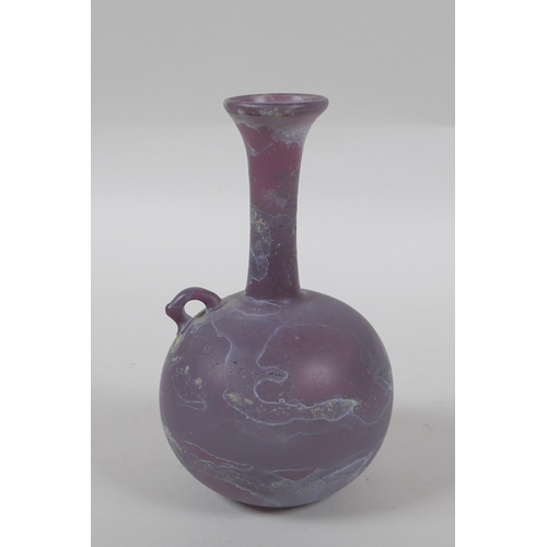 93 - An antique purple glass bottle, 14cm high