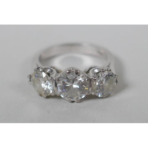 662 - A platinum set three brilliant cut diamond ring, the central stone approx 0.95ct, flanking two stone...