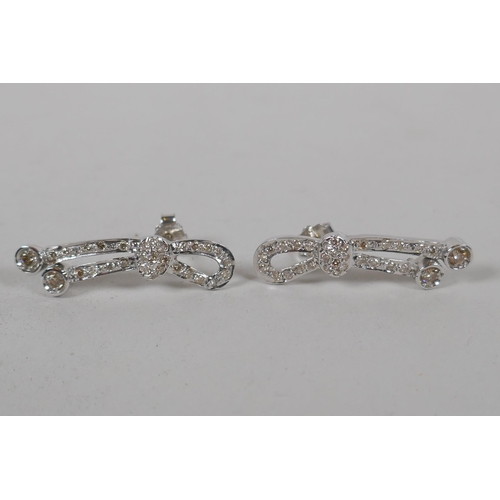 653 - A pair of Iranian white gold and diamond set earrings, indistinctly marked, gold untested, 5.3g gros... 