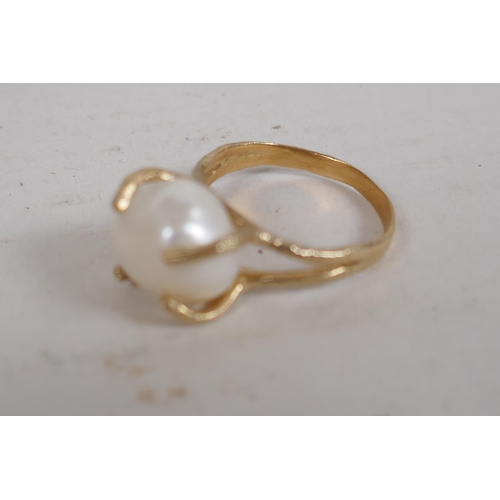 657 - A pair of faux pearl 'Jackie's' (Kennedy) replica earrings, and a 9ct gold ring set with a large pea... 