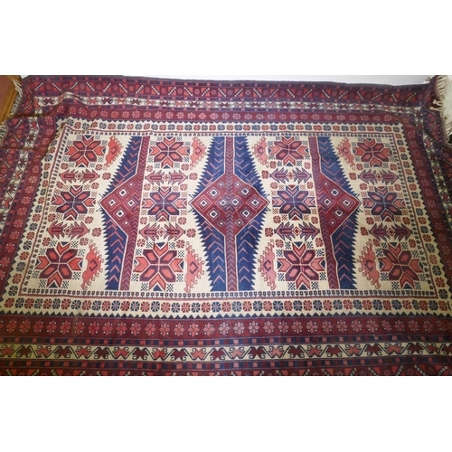 1106 - A Caucasian Kazak wool carpet with geometric designs on a red field, 200 x 300cm