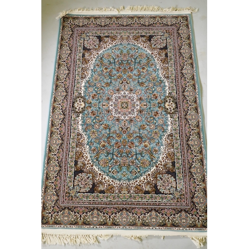 1120 - A fine woven full pile Iranian carpet with traditional floral medallion design on a turquoise field,... 