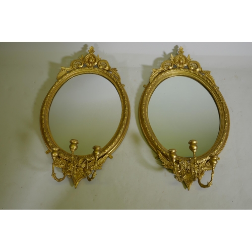 1101 - A pair of Victorian giltwood and composition three branch girondelle wall mirrors, 96cm long