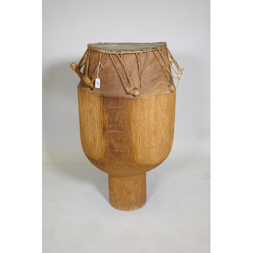 264 - An African Ashanti tribe Atumpan talking drum, 87cm high, 46cm diameter