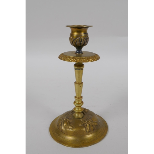 281 - An unusual brass candlestick with Arabic inscription to the base and raised insect decoration, 16cm ... 