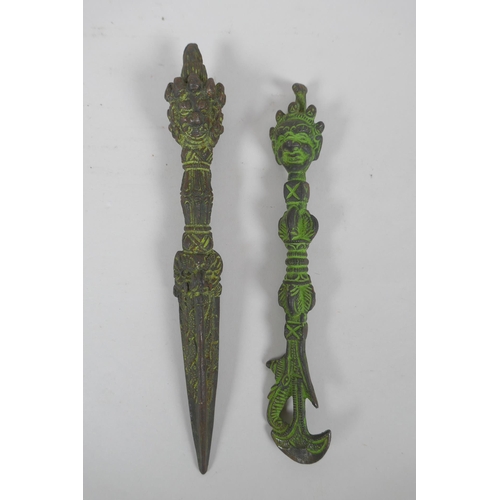 302 - A Tibetan cast iron phurba and kartika with verdigris patina, 21cm long