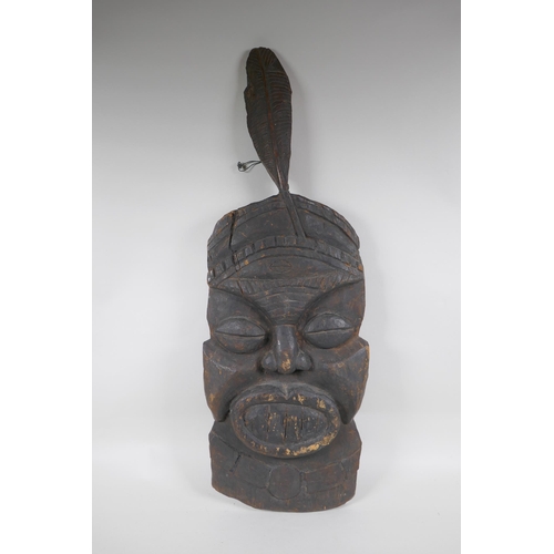 307 - An antique African carved hardwood wall mask, 74cm high x 26cm wide