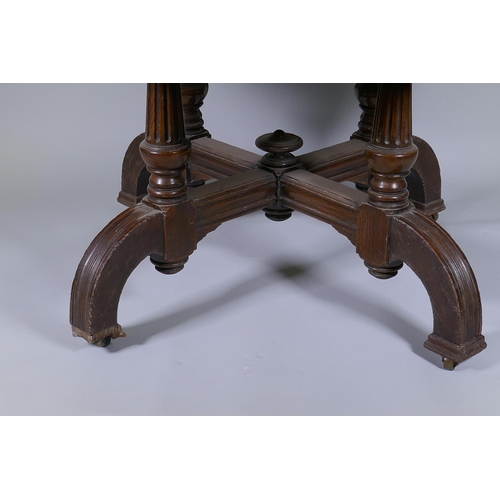 1002 - A Victorian oak centre table with octagonal top, raised on four fluted columns and shaped supports w... 