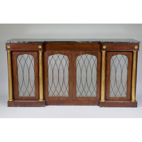 1003 - A Regency mahogany inverted breakfront side cabinet, with vert de mer marble top, three drawers over... 