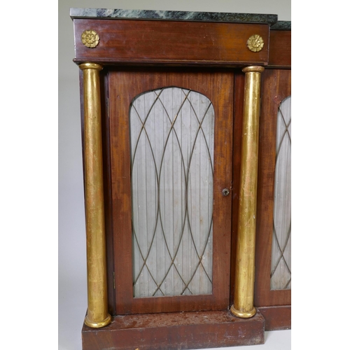 1003 - A Regency mahogany inverted breakfront side cabinet, with vert de mer marble top, three drawers over... 