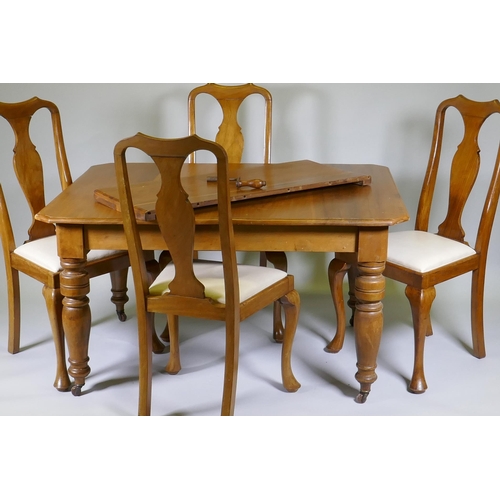 1005 - A Victorian walnut wind out dining table with extra leaf and four associated dining chairs, extended... 