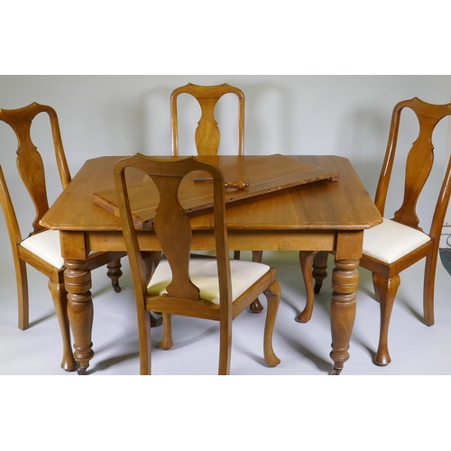 1005 - A Victorian walnut wind out dining table with extra leaf and four associated dining chairs, extended... 