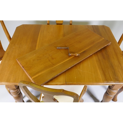 1005 - A Victorian walnut wind out dining table with extra leaf and four associated dining chairs, extended... 