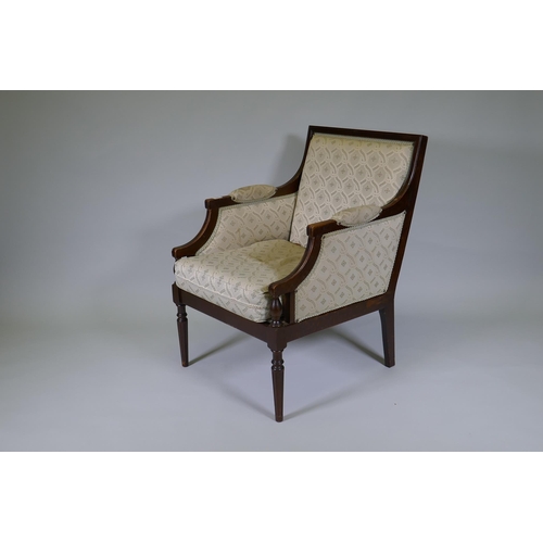 1006 - A French style walnut show frame armchair, raised on fluted turned supports, C20th