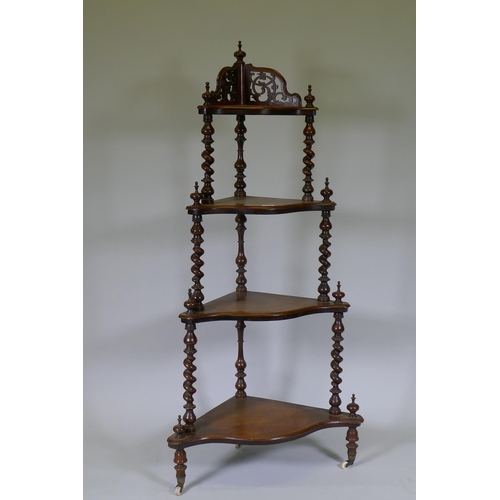 1009 - A Victorian figured walnut corner whatnot with four serpentine front tiers united by barley twist co... 