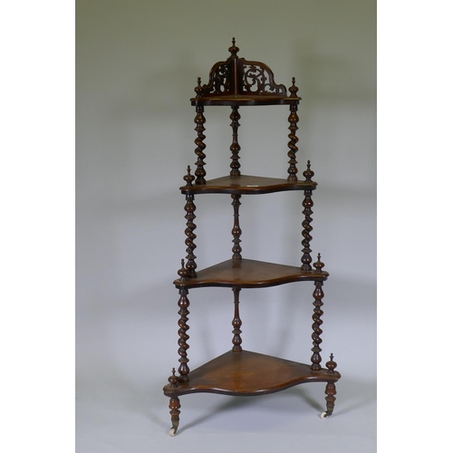 1009 - A Victorian figured walnut corner whatnot with four serpentine front tiers united by barley twist co... 