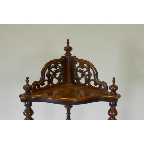 1009 - A Victorian figured walnut corner whatnot with four serpentine front tiers united by barley twist co... 