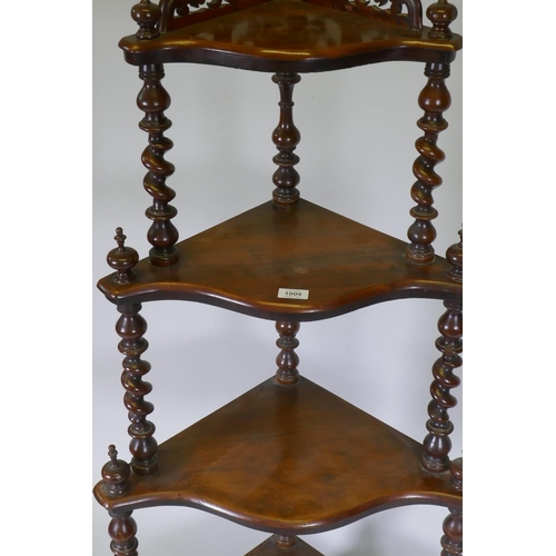 1009 - A Victorian figured walnut corner whatnot with four serpentine front tiers united by barley twist co... 