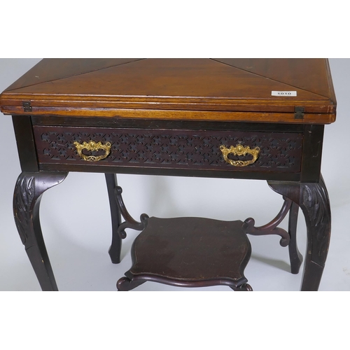 1010 - A Victorian mahogany envelope card table, the single drawer with blind fret decoration, raised on ca... 