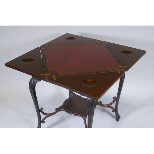 1010 - A Victorian mahogany envelope card table, the single drawer with blind fret decoration, raised on ca... 