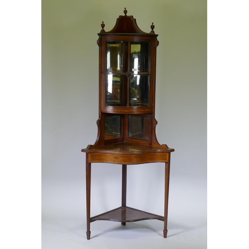 1011 - A Victorian mahogany corner display cabinet with single bow front glazed cupboard, mirror back and s... 