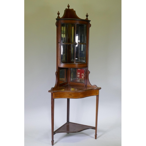 1011 - A Victorian mahogany corner display cabinet with single bow front glazed cupboard, mirror back and s... 