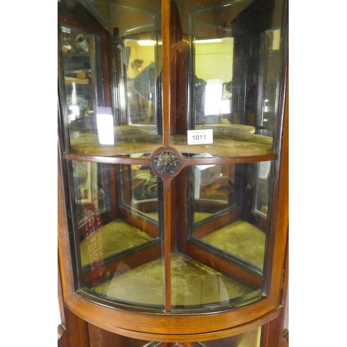 1011 - A Victorian mahogany corner display cabinet with single bow front glazed cupboard, mirror back and s... 