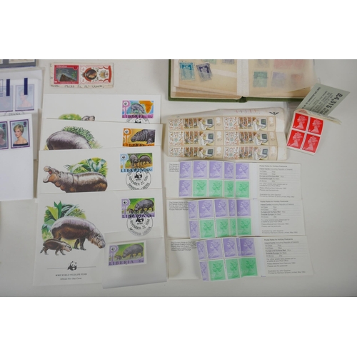 102 - A quantity of world stamps, First Day covers and complete and unused stamp books